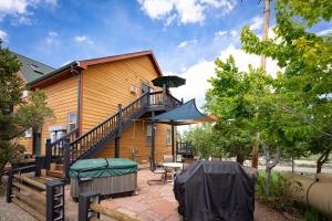 a house with a balcony with a table and an umbrella at Cozy 1BR Mountain View Studio with Fireplace &Deck in Fort Collins