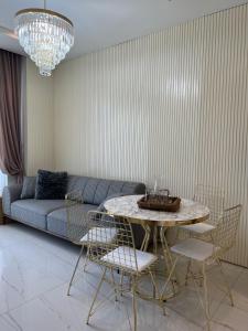 a living room with a couch and a table and chairs at Best Home 38 Triumph in Alanya