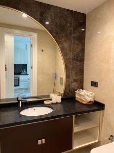 a bathroom with a sink and a mirror at Best Home 38 Triumph in Alanya