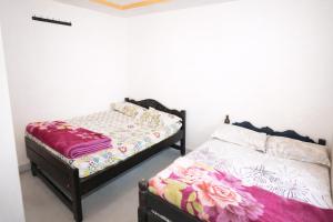 a bedroom with two twin beds in a room at Aroli Homestay in Kalasa