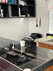 a kitchen with a black counter top with a stove at María 1 in Barahona