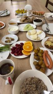 a wooden table with plates of food on it at Hotel Giorgi in Tsqaltubo