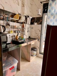 a kitchen with a sink and a counter top at Sugar Waves in Navi Mumbai
