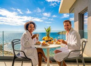 a man and a woman sitting at a table with food at condostmaarten by the sea -Adults Only- in Koolbaai