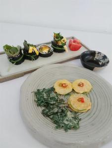 a plate of food with vegetables on a table at Ernie MyeongDon'g Sation 1Min, Anytime Check In in Seoul