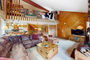 a living room with a couch and a coffee table at Pine Ridge Condos in Breckenridge