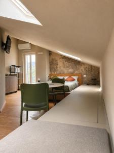 a room with a bed and a table and chairs at Agriturismo Terra Madre in Rapallo