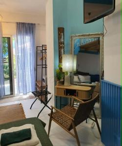 a room with a mirror and a chair and a desk at Hotel Villa Anais in Prinos