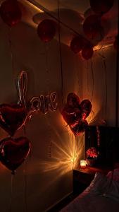 a room with red hearts hanging from a wall at Anubis Pyramids View Inn in Cairo