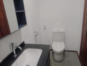 a bathroom with a sink and a toilet at Gecko Lodge in Tetebatu