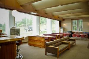 a large room with a ping pong table and chairs at 三笠の宿 Mikasanoyado in Kiso