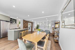 a kitchen and dining room with a table and chairs at 3 Bedroom City Apt, Big Yard & Park Views - Sleeps 7 in Adelaide +29 photos