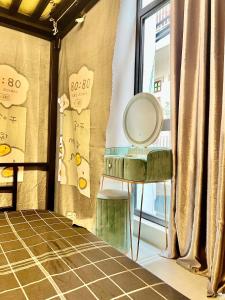 a room with a mirror and a table and a window at Hanoi Backpacker Home in Hanoi