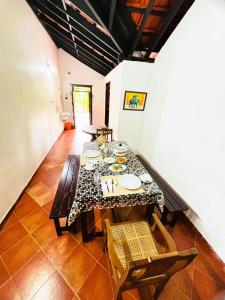 a dining room with a table and some chairs at Vilayara Heritage Retreat -Kozhikode in Kunnamangalam