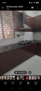a view of a kitchen with a stove top oven at Hotel Empress Gold in Agra