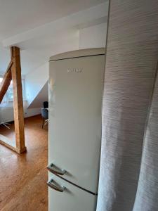 a white refrigerator in a room with at Süße Marie 18 - Coffee for free - in Karlsruhe
