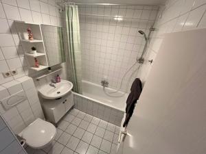 a white bathroom with a toilet and a sink at Süße Marie 18 - Coffee for free - in Karlsruhe