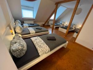three beds in a room with a attic at Süße Marie 18 - Coffee for free - in Karlsruhe