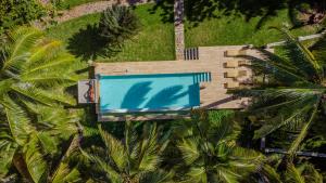 an overhead view of a swimming pool on a house with palm trees at Maeva Beach in Sainte Marie
