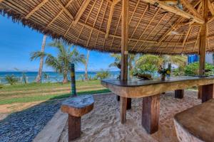 an outdoor bar with a view of the ocean at Villa Lokobe in Hell-Ville