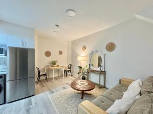 a living room with a couch and a table at sweet home in Richmond
