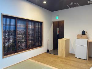 a room with a window with a view of a city at Besso城前 in Himeji +20 photos
