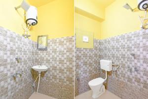 a bathroom with a toilet and a sink at Super Hotel O Chittaranjan Railway Station Formerly Khalsa Lodge in Āsansol