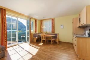 a kitchen and dining room with a table with a view at Apparthotel Bliem in Schladming