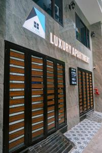 a lobby of a library with two sets of doors at Auri House in Hanoi