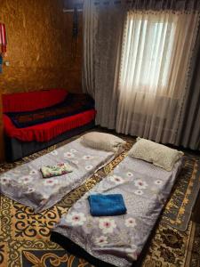a bedroom with two beds and a window at Oskon Guesthouse in Kyzart +13 photos