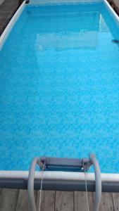 a swimming pool with blue water at Tra storia e realtà in Sardara