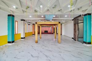 a large room with a stage in the background at Treebo Chanakya Palm in Chhatikara