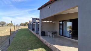 a side view of a house with a table outside at GROOTVALLEI SELF CATERING Units in Mahikeng