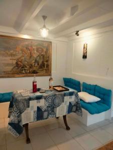 a living room with a blue couch and a table at Casa MUSA in Keratea