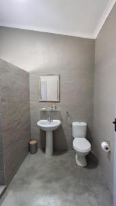 a bathroom with a toilet and a sink at GROOTVALLEI SELF CATERING Units in Mahikeng +22 photos