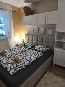 a bedroom with a bed with two shoes on it at Blue harmony 1 Malinska in Malinska