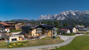 an aerial view of a village with mountains in the background at Apparthotel Bliem in Schladming