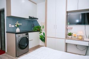 a kitchen with a washing machine in a room at Auri House in Hanoi