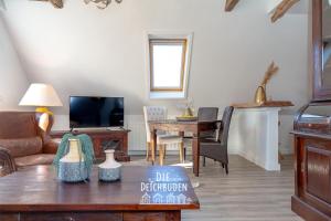 a living room with a couch and a table at Box-10 in Büsum
