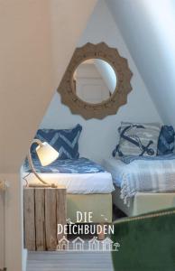 a bedroom with two beds and a mirror on the wall at Box-10 in Büsum