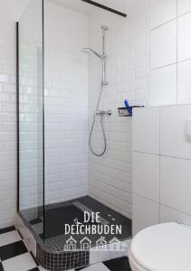 a bathroom with a shower with a glass door at Box-10 in Büsum +20 photos