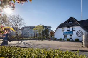 a building with a clock on the side of a street at Box-10 in Büsum