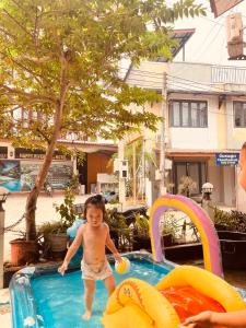 a young child playing in a swimming pool at Vangvieng dream house in Vang Vieng