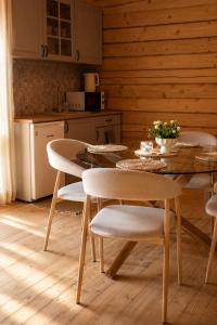 a dining room with a table and chairs in a kitchen at Nice House in Maidan Village