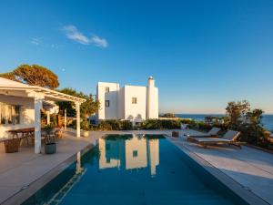 a swimming pool in front of a house at myMykonos Villa I in Platis Gialos