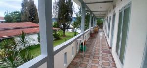 a balcony of a house with a view of a yard at Kings guest house in Tuktuk Siadong