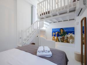a bedroom with a bunk bed with a ladder at myMykonos Villa I in Platis Gialos +59 photos