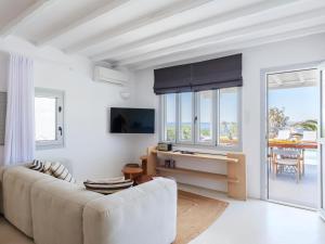 a living room with a couch and a table at myMykonos Villa I in Platis Gialos