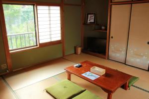 a living room with a coffee table and a window at HOSTEL Bion in Taki