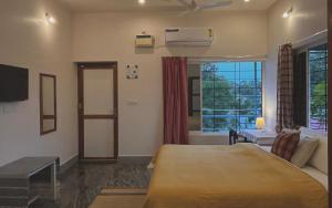 a bedroom with a bed and a large window at BrightMoon_Homestay in Pondicherry